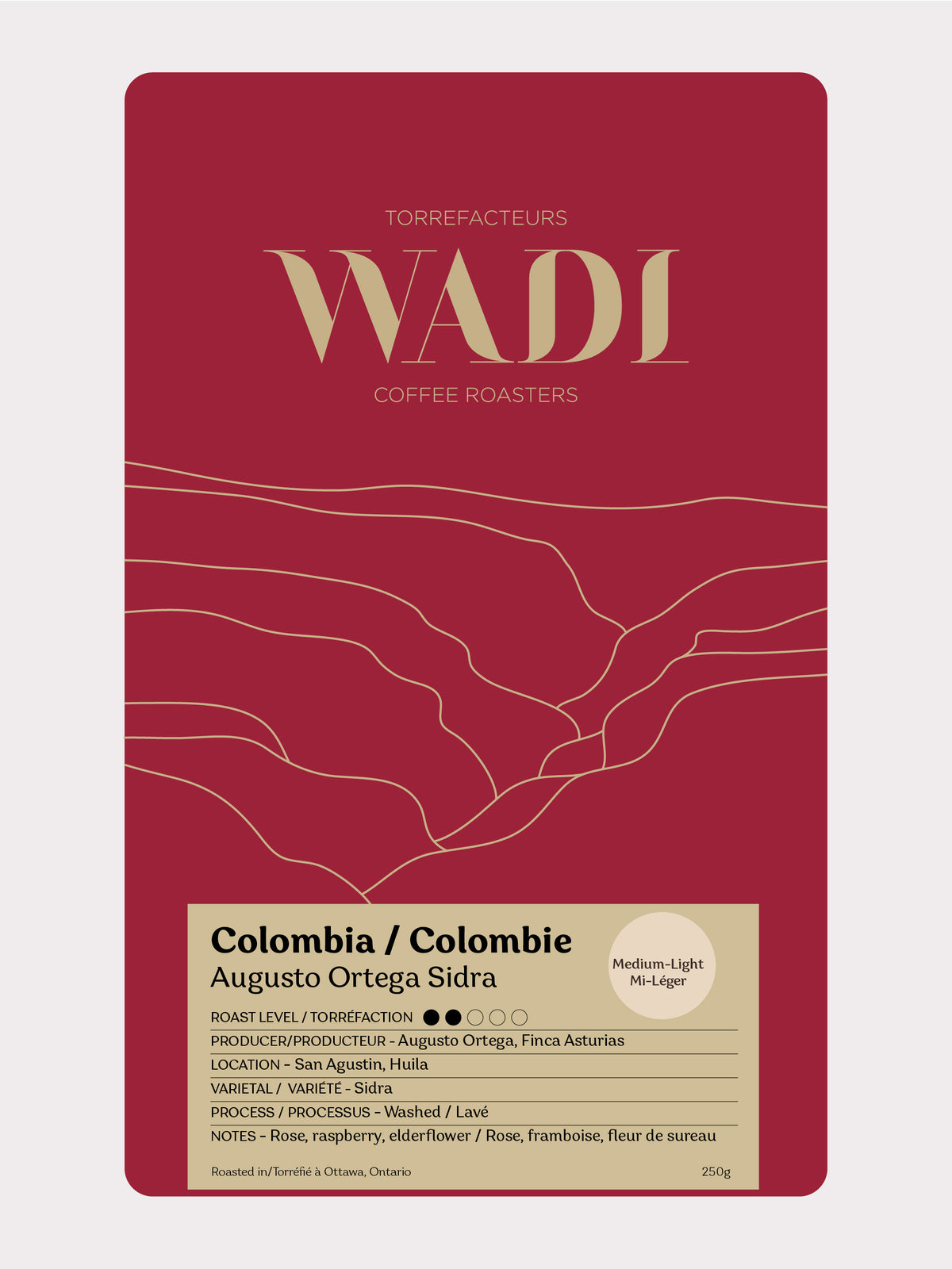 Bag of Colombia Augusto Ortega Sidra coffee from Wadi Coffee Roasters with colorful label and fresh coffee beans.